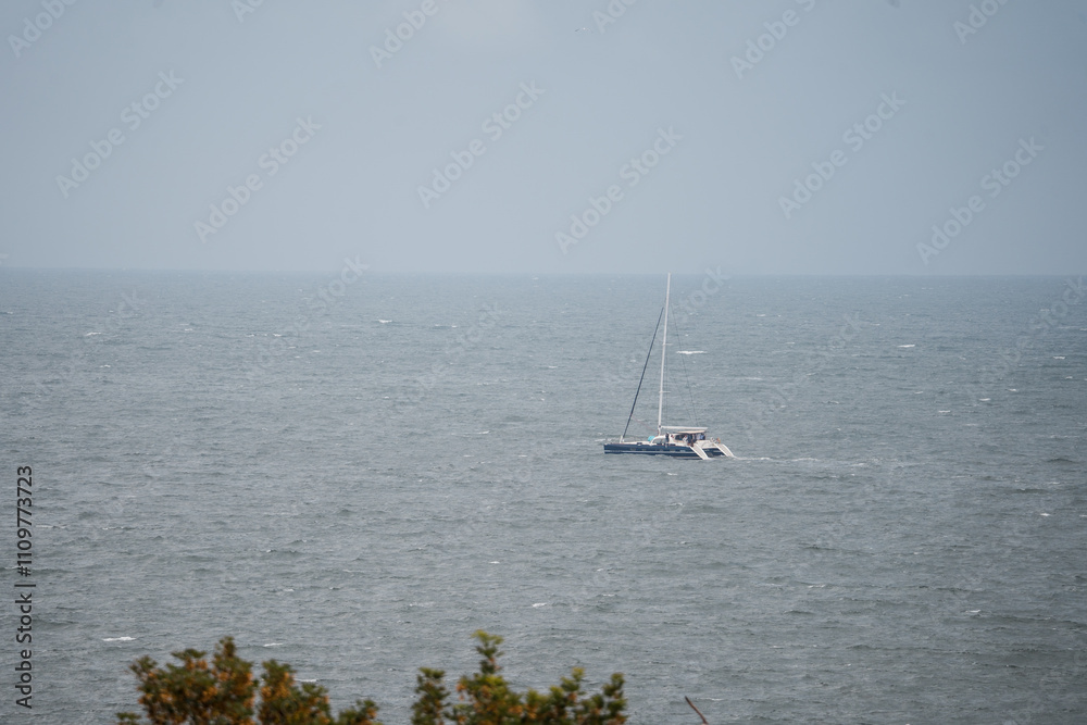 A solitary ship sails in the distance on the vast expanse of the Black Sea, its silhouette faintly visible against the horizon. A solitary ship sails in the distance on the vast expanse of the Black Sea, its silhouette faintly visible against the horizon.