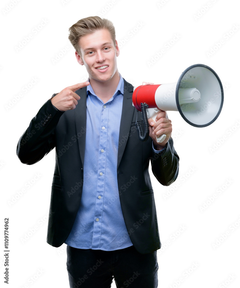 Young handsome blond man holding a megaphone very happy pointing with hand and finger to the side Young handsome blond man holding a megaphone very happy pointing with hand and finger to the side