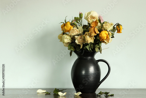 Tableau sur toile A faded flower arrangement in a pewter glazed pottery jug