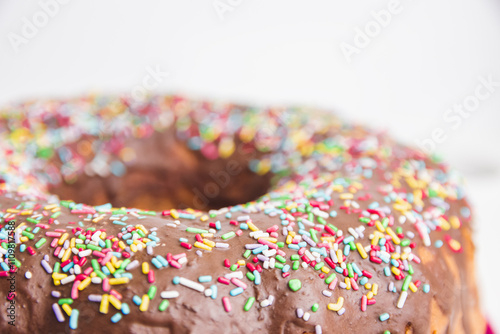 Traditional Gugelhupf cake with chocolate topping and colorful sprinkles photo