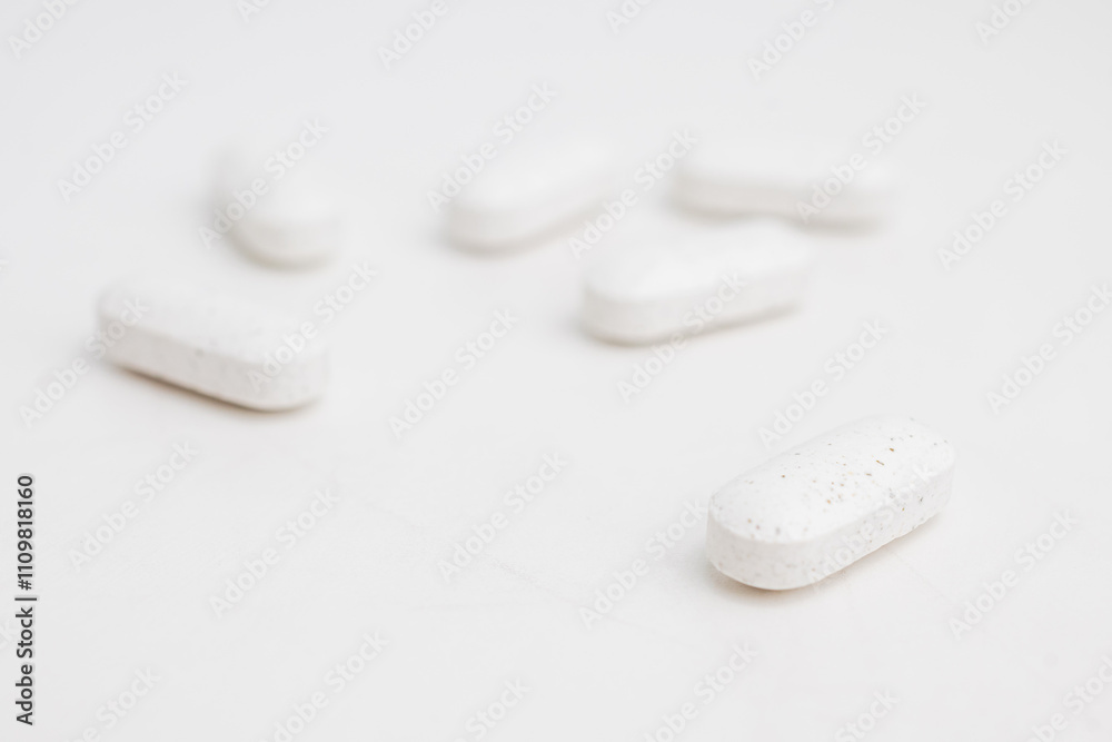White supplement pills close up. Dietary supplement. Alternative medicine. White supplement pills close up. Dietary supplement. Alternative medicine.