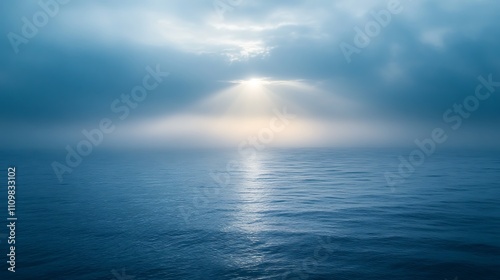 Wallpaper Mural Sunbeams pierce through misty clouds over calm ocean. Torontodigital.ca