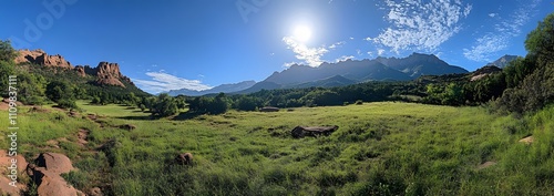 Sunny Meadow Landscape With Majestic Mountain Range