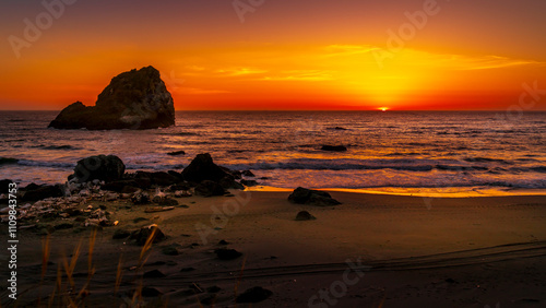 Sunset over the California Coast ate the rock formation called Hunter Rock near Crescent City.