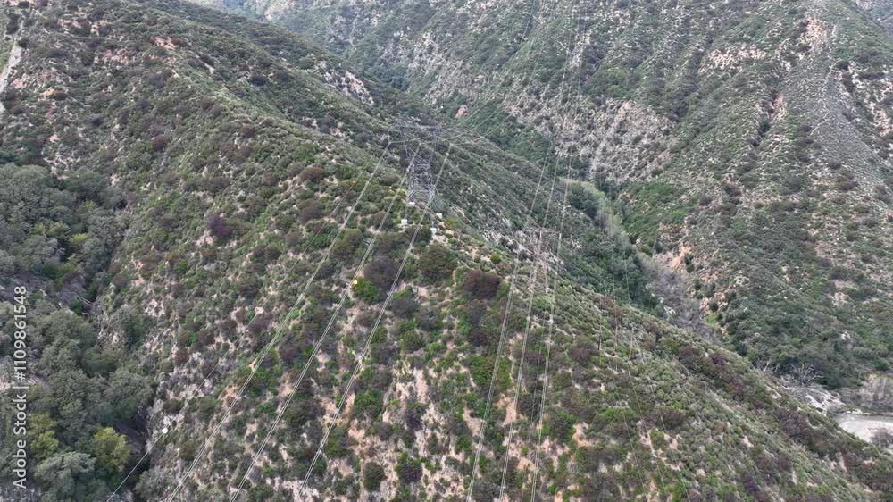 Aerial shot of power lines running through the  rugged San Gabriel Mountains near Los Angles California