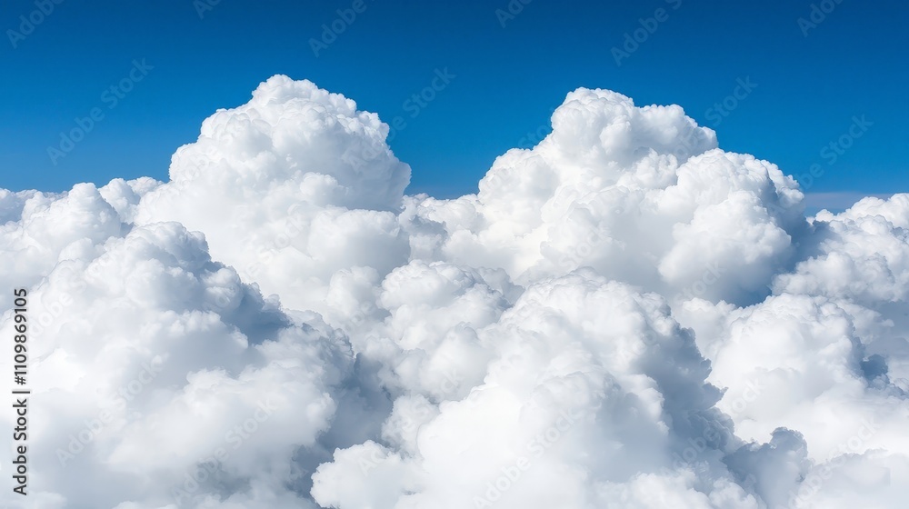Aerial view of fluffy cumulus clouds against a vibrant blue sky. Aerial view of fluffy cumulus clouds against a vibrant blue sky.
