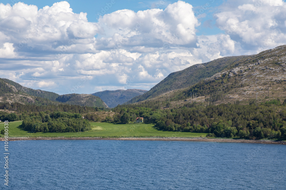 Beautiful Green Farm Land Along the Coast in Northern Norway near Kråkøya, in the Horsvær Area, Midsummer Day, Puffy Clouds Beautiful Green Farm Land Along the Coast in Northern Norway near Kråkøya, in the Horsvær Area, Midsummer Day, Puffy Clouds