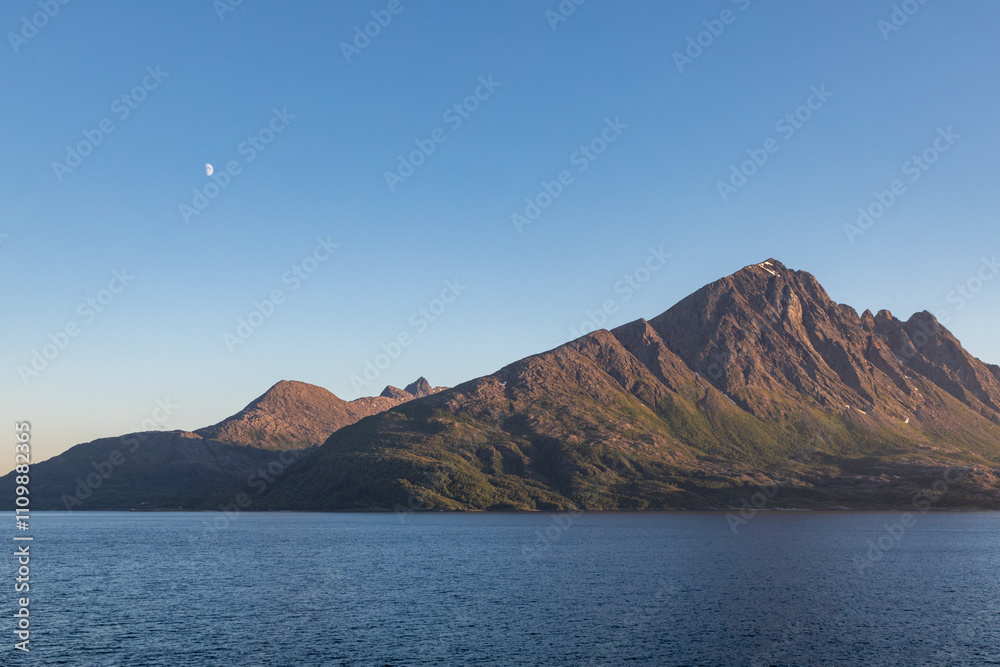 Moonrise at Sea Over the Mountains During Mid Summer in Norway When the Sun Never Sets, From the Deck of a Cruise Ship Moonrise at Sea Over the Mountains During Mid Summer in Norway When the Sun Never Sets, From the Deck of a Cruise Ship
