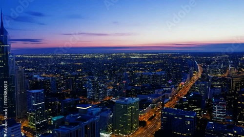 Wallpaper Mural A panoramic city skyline at dusk, showcasing illuminated buildings and urban landscape. Torontodigital.ca