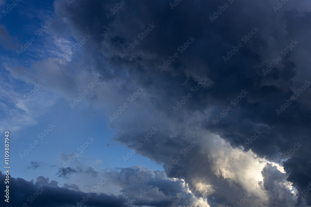 Dramatic sky with dark clouds at sunset, natural background. Dramatic sky with dark clouds at sunset, natural background.