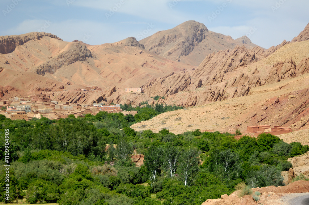 Fototapeta premium Desolate valley village and green farmland oasis Atlas Mountains Morocco