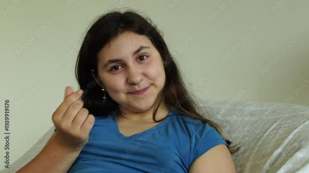 Teenager girl sits on the chair with smartphone Teenager girl sits on the chair with smartphone