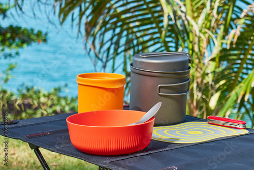 ultralight kitchen set for traveling on a folding table, in nature with a tropical view