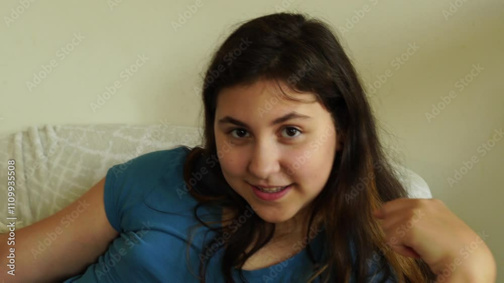 Teenager girl sits on the chair with smartphone Teenager girl sits on the chair with smartphone