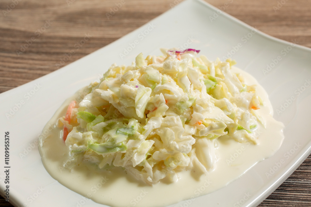 A view of a plate of coleslaw. A view of a plate of coleslaw.