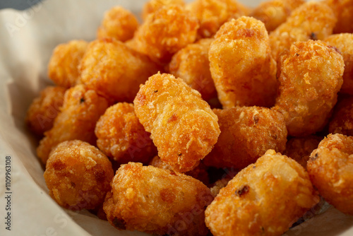 A closeup view of a basket of tater tots.