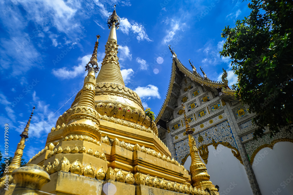 Fototapeta premium Chapel and Gold Pagoda, Lanna Architecture, Symbols of Buddhism, South East Asia at Ko Klang temple, Muang Chiang Mai, Chiang Mai, Northern Thailand
