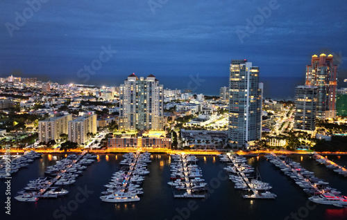 Luxury yacht at night. Miami south beach view. Yacht club. Marina in night Miami. Downtown Miami marina with luxury illuminated yacht. Summer vacation. Luxury South beach marina. Waterfront views