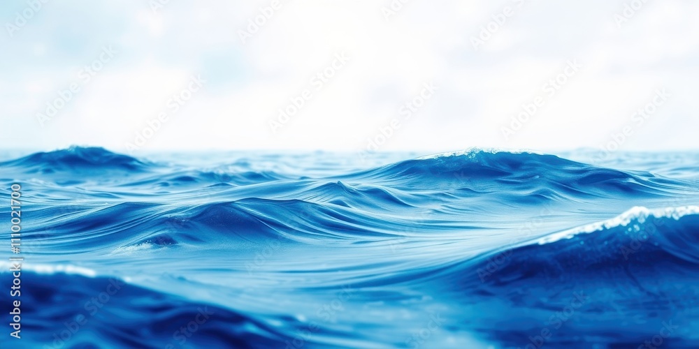 A close-up view of the ocean surface, showcasing the gentle undulations of the waves, their deep blue hues illuminated by the soft light of the sky. A close-up view of the ocean surface, showcasing the gentle undulations of the waves, their deep blue hues illuminated by the soft light of the sky.