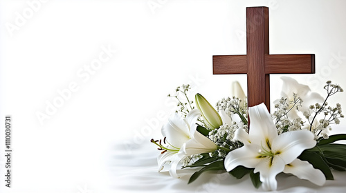 Wooden cross surrounded by white lilies and greenery, symbolizing Easter with copy space for text photo