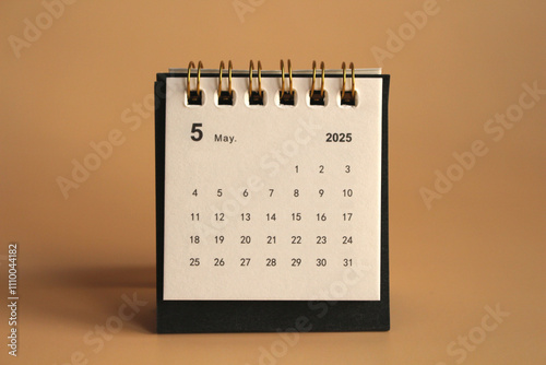 Monthly calendar template for the new year 2025 desk calendar,isolated on Beige background. photo