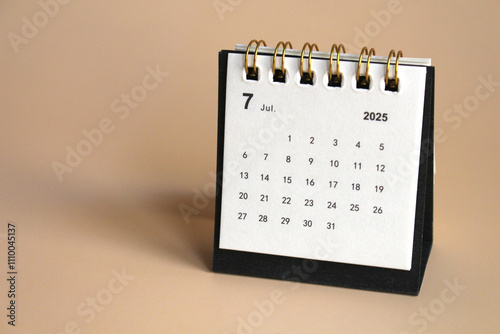 Monthly calendar template for the new year 2025 desk calendar,isolated on Beige background. photo