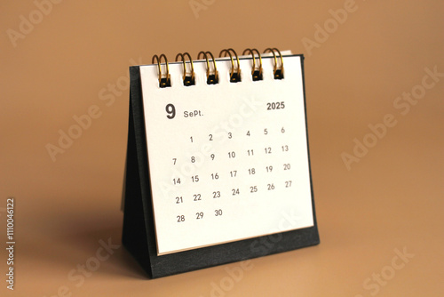 Monthly calendar template for the new year 2025 desk calendar,isolated on Beige background. photo