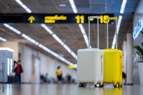Fototapeta Naklejka Na Ścianę i Meble -  Two suitcases in an empty airport hall, traveler cases in the departure airport terminal waiting for the area, vacation concept, blank space for text message or design, travel.