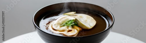 A steaming bowl of miso soup with tofu, mushrooms, and green onions