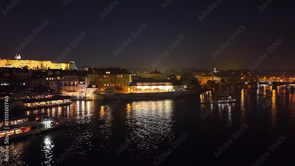 Vltava River at night in the illuminated city of Prague, Czech Republic. Vltava River at night in the illuminated city of Prague, Czech Republic.