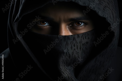 Intense Gaze of Mysterious Hooded Figure with Dark Eyes photo