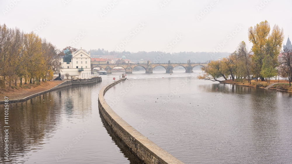 Vltava River on a foggy day overlooking Charles Bridge and medieval buildings, Prague. Vltava River on a foggy day overlooking Charles Bridge and medieval buildings, Prague.