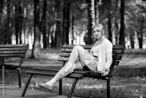 Portrait of a young beautiful girl in the summer in an urban environment. Black and white photo.