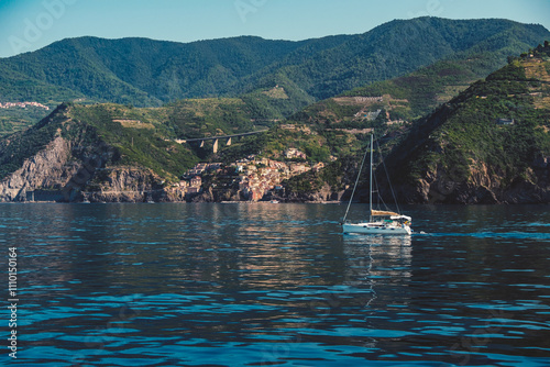 coast of Riomaggiore with a sailboat in Cinque Terre