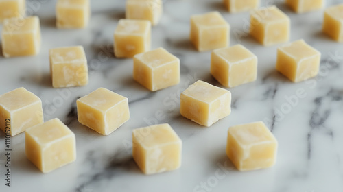 Cheese cubes scattered on a marble surface, artistic arrangement