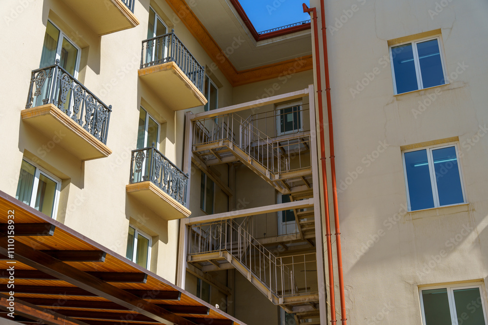 A building with a balcony and a fire escape A building with a balcony and a fire escape