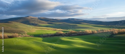 Aerial view of a scenic green landscape at dawn with rolling hills and distant mountains under a beautiful sky