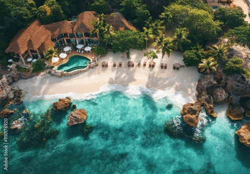 Aerial View of Tropical Paradise with Sandy Beach, Crystal Clear Water, Lush Greenery, Luxury Villa, and Relaxing Poolside Lounge Chairs under the Sun