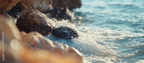 Ocean waves crashing over rocks in a serene seascape with glistening water droplets and natural coastal beauty.