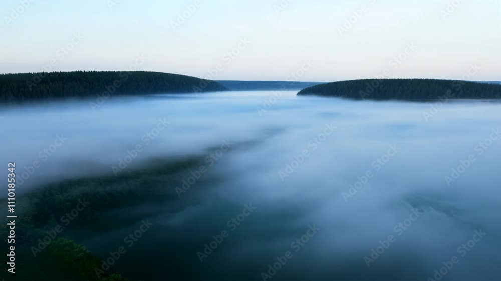 Ethereal timelapse video of fog rolling over a lake in the early morning, featuring a slow pan and ethereal lighting Ethereal timelapse video of fog rolling over a lake in the early morning, featuring a slow pan and ethereal lighting