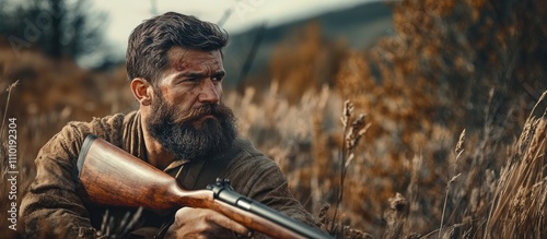 Bearded hunter in natural setting holding rifle during hunting season showcasing passion and skill in wildlife harvesting activities photo