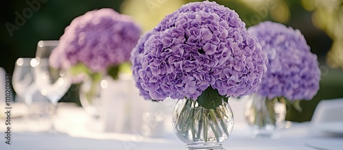 Elegant purple wedding floral arrangement with hydrangeas at a reception featuring soft focus and ample copy space on the left side. photo