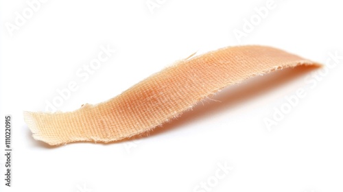 Adhesive bandage detached on a clean white background showcasing its texture and color with clear visibility of its edges photo