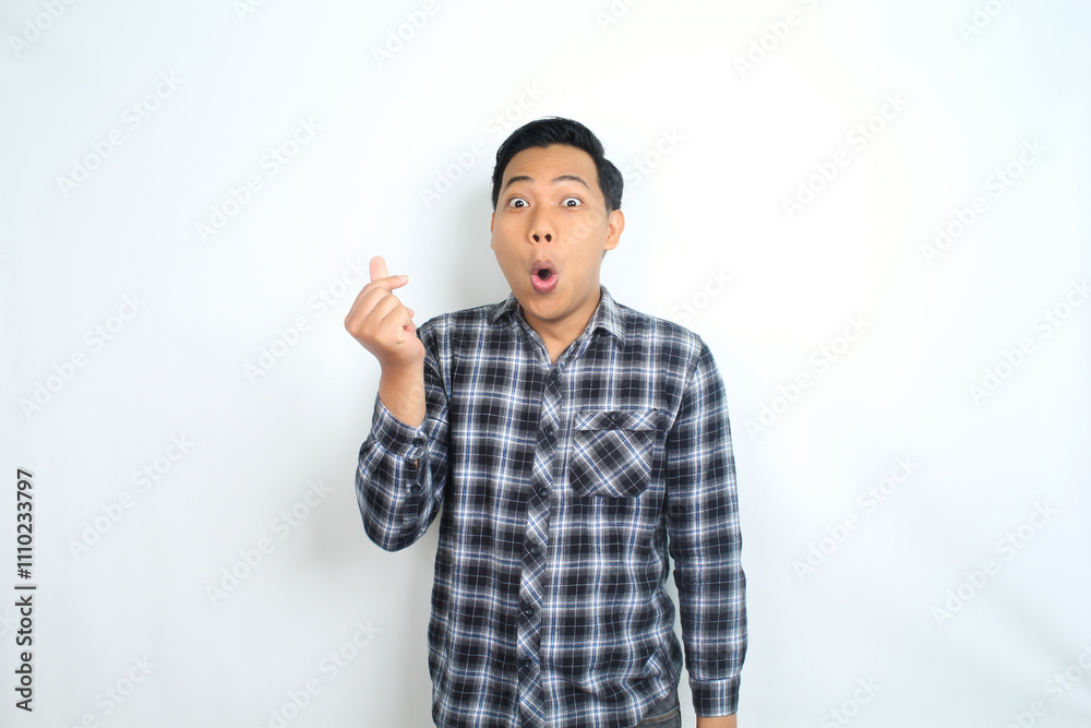 Fototapeta premium asian man showing mini heart shape using finger with shocked and funny face wow expression isolated on white
