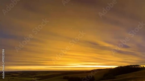 A time lapse Daylight fading into a starlit sky in a rural area