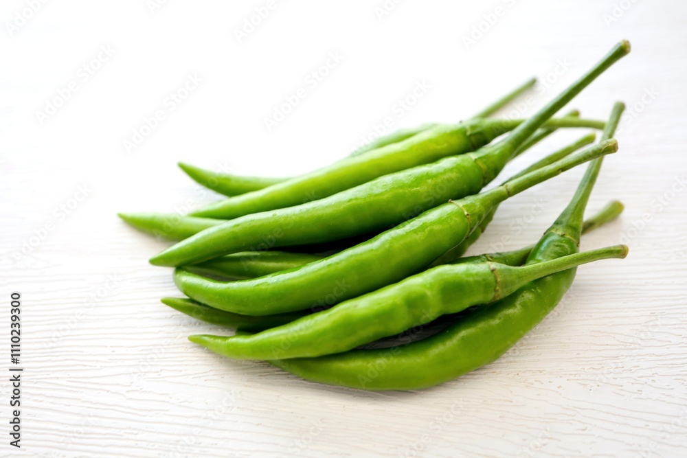 Green chili,spur chilli, spur chili pepper, spur pepper, long green pepper on white background Green chili,spur chilli, spur chili pepper, spur pepper, long green pepper on white background