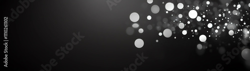 Abstract light bokeh background with soft, blurred circles in a black atmosphere.