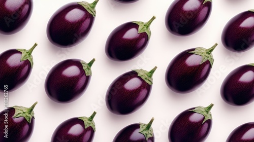 Fresh eggplant fruits arranged neatly on a clean backdrop showcasing their vibrant color and unique shape ideal for culinary or agricultural themes