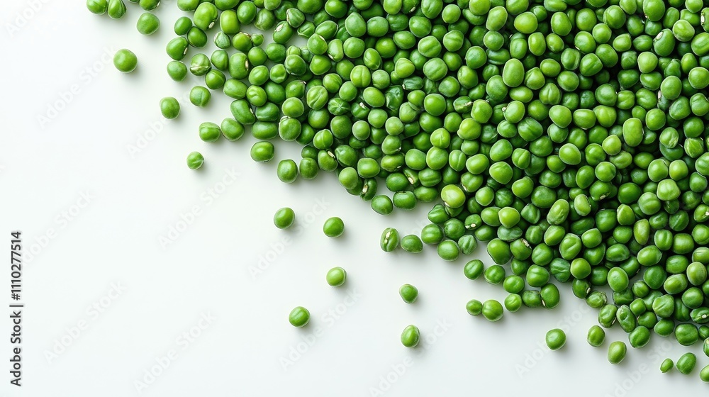 Vibrant green mung beans scattered on a clean white background showcasing their natural color and texture for culinary or health-related themes Vibrant green mung beans scattered on a clean white background showcasing their natural color and texture for culinary or health-related themes
