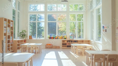 Bright, airy classroom-style room with modular seating, sleek white tables, minimalist decor, and natural light streaming in from big windows